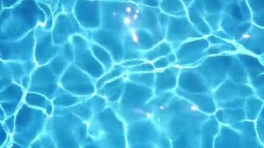 Ripples and sun glare on the turquoise water in the pool. High quality 4k footage