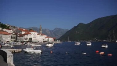 Motor boats rock on the waves at the pier of Perast. Montenegro. High quality FullHD footage
