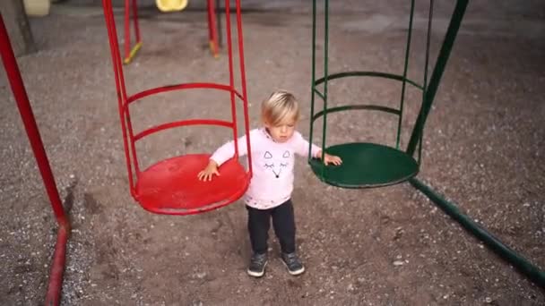 Little Girl Swings Swing While Standing Next Them Playground High — Stockvideo
