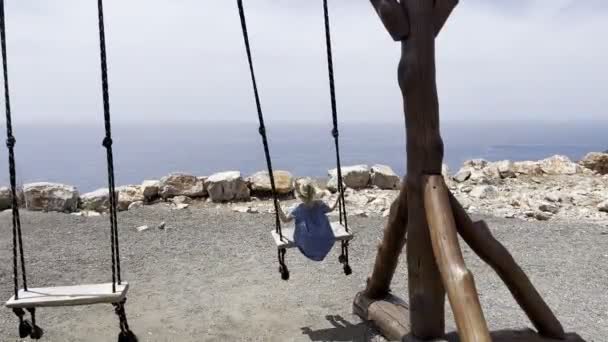 Little Girl Swings Wooden Swing Mountain Sea Back View High — Stock videók