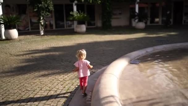Κοριτσάκι Περπατάει Στο Σιντριβάνι Και Αγγίζει Νερό Χέρια Της Υψηλής — Αρχείο Βίντεο