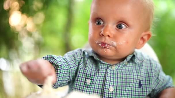 Little Boy Eats Cake Cream His Hands Dirtying His Face — Stock video