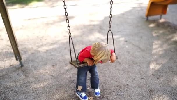Little Girl Swings Chain Swing Her Stomach Playground High Quality — Video Stock