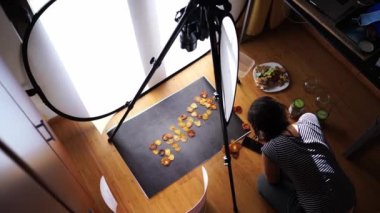 Photographer stoker taking a photo of dried fruit snack word on dark background. High quality 4k footage