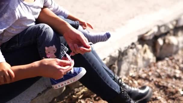 Mom Tying Shoelaces Sneaker Leg Small Child Sitting Her Lap — Stock Video