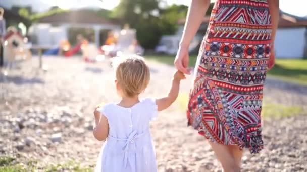 Little Girl Learns Walk Stumbling Holding Her Mother Finger Back — Stockvideo