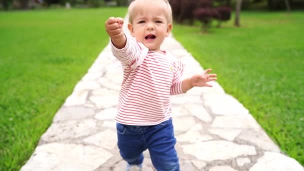 Little Girl Takes Her First Steps Path Garden Falls High — Video Stock
