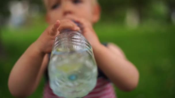 Little Girl Drinking Water Lemon Bottle High Quality Footage — Stok video
