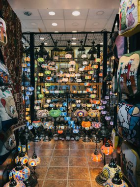 Multi-colored lamps, chandeliers and light fixtures hang on shelves in a supermarket. High quality photo