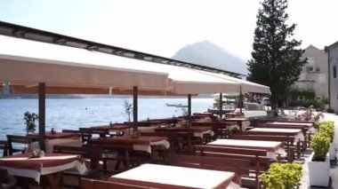 Covered restaurant on the sea promenade in Perast. High quality FullHD footage
