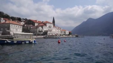 Moored boats sway on the sea waves off the coast of Dobrota. Montenegro. High quality FullHD footage