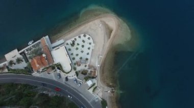 Hotel with a private beach on a coastal ledge by the sea. Drone. High quality 4k footage