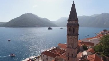 Old bell tower of the Church of St. Nicholas overlooking the islands in the Bay of Kotor. Drone. High quality 4k footage