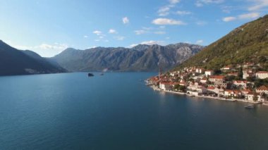 Old houses with red tiled roofs at the foot of the mountains. Perast. High quality 4k footage