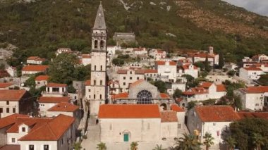 Church of St. Nicholas with a high clock tower on the seashore. Perast, Montenegro. High quality 4k footage
