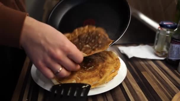 Man Removes Ruddy Pancake Frying Pan His Hand Puts Plate — Vídeo de stock