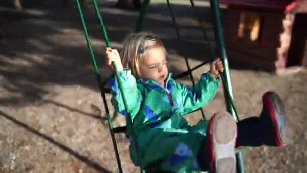 Mała Dziewczynka Kombinezonie Huśta Się Huśtawce Placu Zabaw Wysokiej Jakości — Wideo stockowe