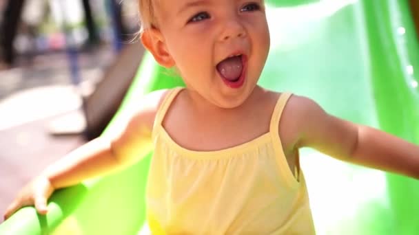 Little Girl Laughing Her Mouth Open While Sitting Slide High — Stockvideo