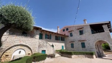 Old stone house with terraces and green wooden shutters on the windows. High quality 4k footage