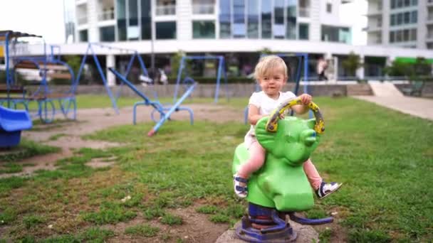Little Girl Sitting Swing Spring Playground High Quality Footage — Vídeos de Stock