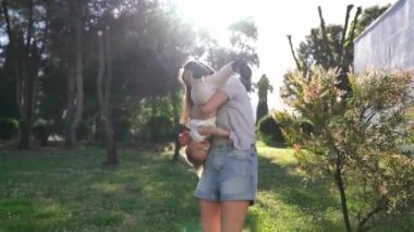 Mom holds a little girl sliding down her legs. High quality 4k footage