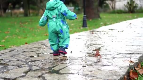 Little Girl Rubber Boots Jumping Puddles Paved Path Park High — Stockvideo