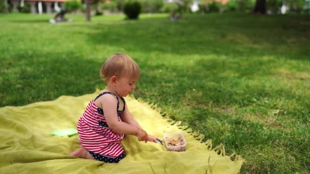 Little Girl Sits Blanket Lawn Eats Nuts Spoon High Quality — Stock videók