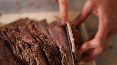 Cook sliced the roast beef and put the knife on the cutting board. High quality 4k footage