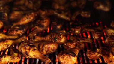 Chicken legs are baked on a grill over coals. High quality 4k footage