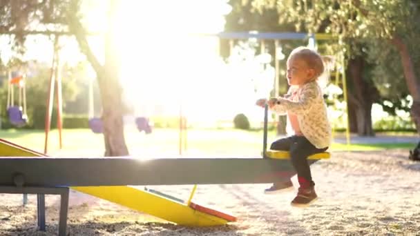 Little Girl Swings Swing Balancer Holding Handle High Quality Footage — Vídeo de stock