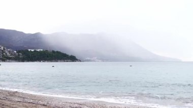 View from the sea coast to the fog over the mountains. High quality 4k footage