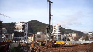 Drilling rig drills the ground to install piles. High quality 4k footage