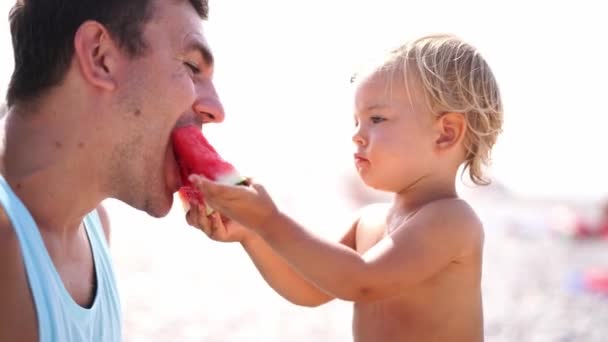 Little Girl Eats Watermelon Treats Dad Beach High Quality Footage — Vídeo de stock