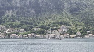 Motorboat sails along the sea along the coast of a resort town. High quality 4k footage