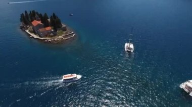 Excursion boat floats near the island of St. George. Montenegro. High quality 4k footage