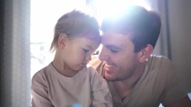 Dad and little daughter hug and kiss each other cheeks. High quality 4k footage