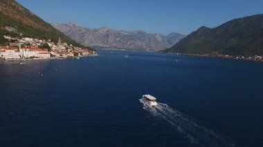 Motorboat sails to the coast of Perast. Drone. High quality 4k footage