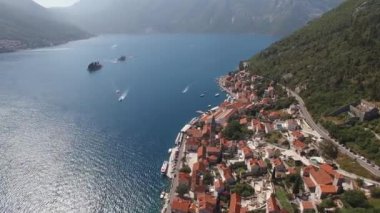 Motor boats sail between the islands of the Bay of Kotor and the coast of Perast. Drone. High quality 4k footage