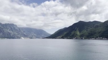Blue sea surrounded by green mountain range. High quality 4k footage