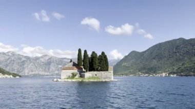 Island of St. George against the backdrop of the mountains in the Bay of Kotor. Montenegro. High quality 4k footage