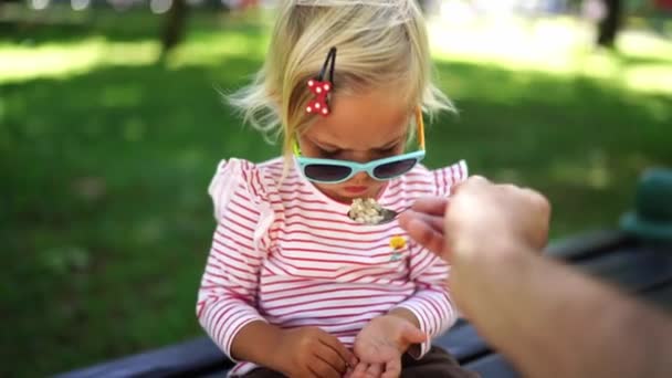 Little Girl Being Spoon Fed Porridge Park High Quality Footage — Vídeos de Stock