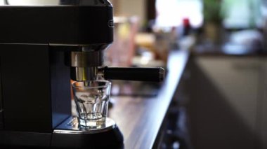 Man turns on the coffee machine and waits for coffee to be prepared. High quality 4k footage
