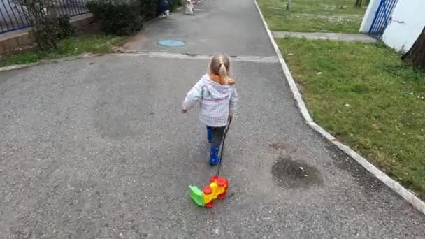 Little Girl Runs Toy Car Rope Mother Playing Her Child — Stockvideo