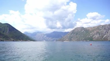 Wind drives the sea waves against the backdrop of a mountain range and a cloudy sky. High quality FullHD footage