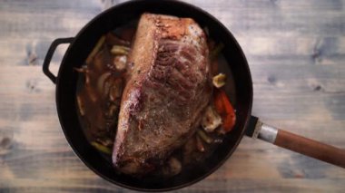 Steam rises over roast beef in a pan on the table. High quality 4k footage