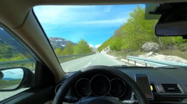 View from the windshield of a car on a high mountain road. High quality 4k footage