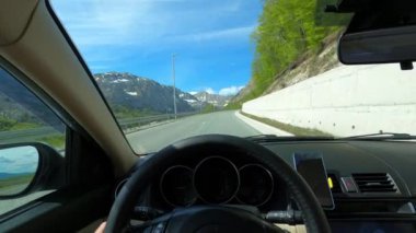 View from behind the wheel of a car on a mountain highway in front of a tunnel. High quality 4k footage
