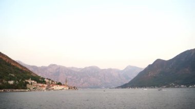 Motor boat floats on the sea against the backdrop of the mountains. High quality 4k footage