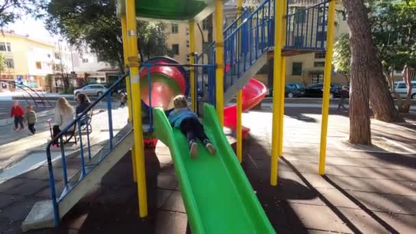 Little Girl Slides Slide Her Stomach Feet First High Quality — Stockvideo