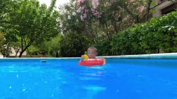 Little Girl Rubber Duck Her Hand Swims Inflatable Ring Pool — Video Stock